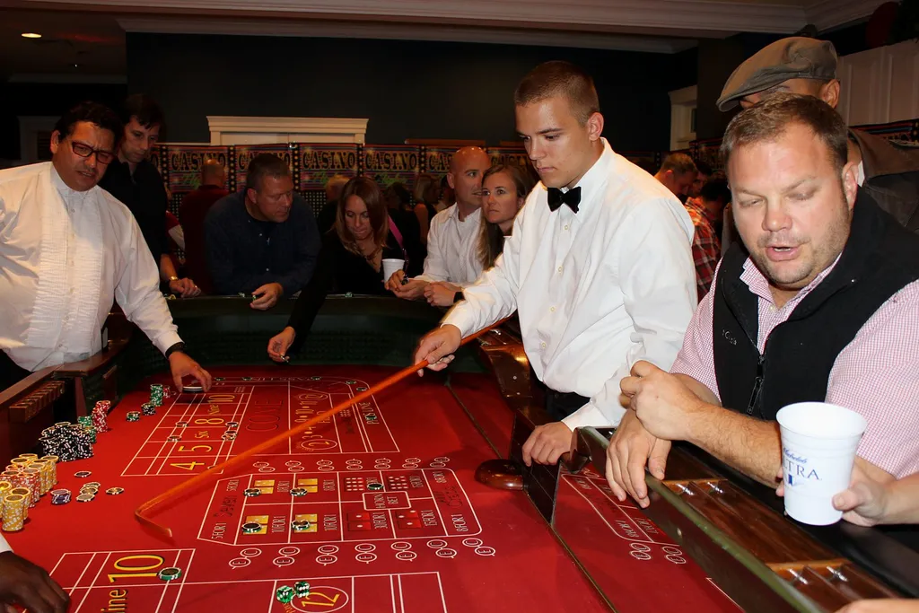 Dealer leading a crowded craps table