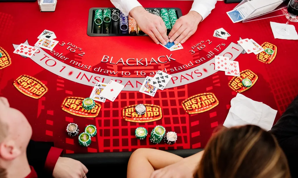Blackjack table set with cards, chips, and Metro Casino fun money